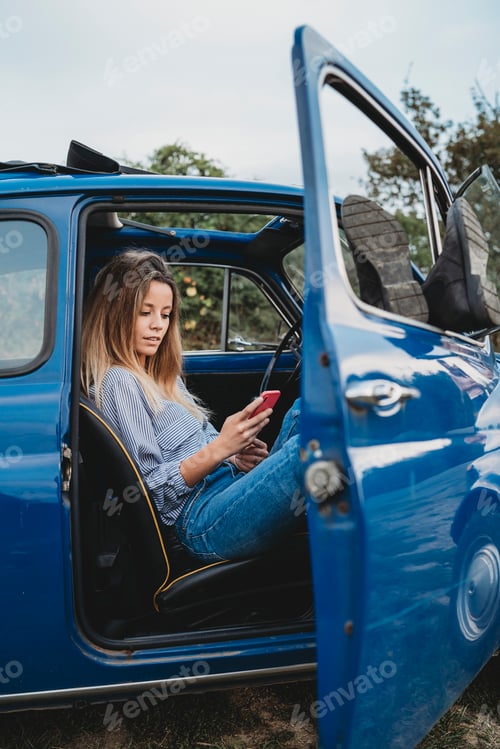 Preview: Woman using smartphone inside car