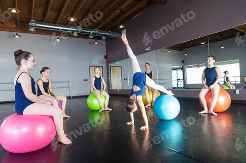 Preview: Group of kids in inflatable exercise ball class in dance studio