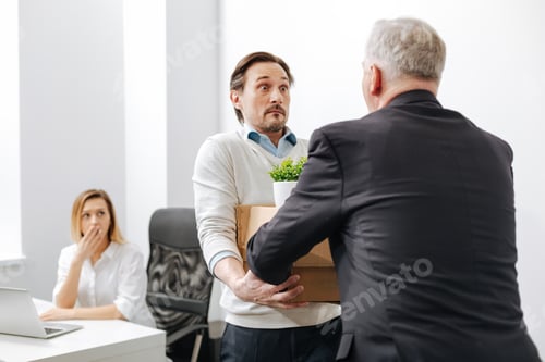 Preview: Perplexed Worker Receiving The Box With Belongings From The Employer