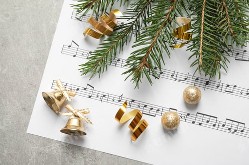 Preview: Christmas decorations and music sheet on grey stone table, flat lay