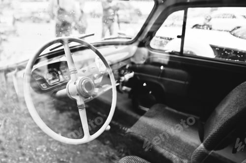 Preview: Interior and steering wheel on old vintage retro car. Black and white photo