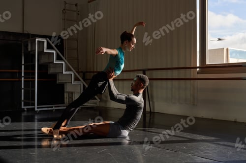 Preview: Couple of black boy and white girl in a class doing a training in ballet academy