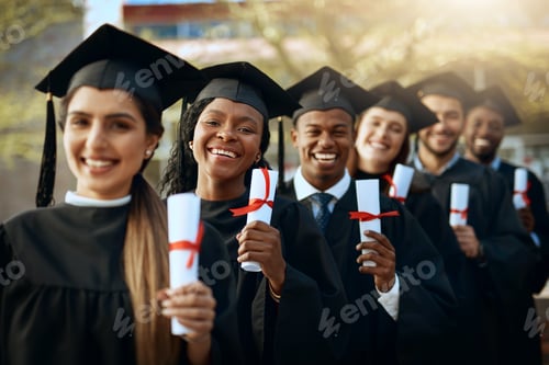 Preview: Portrait of a group of young students holding their diplomas on graduation day