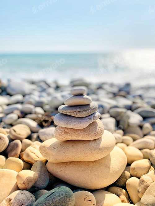 Preview: cairns pile stack stacked on a pebble beach
