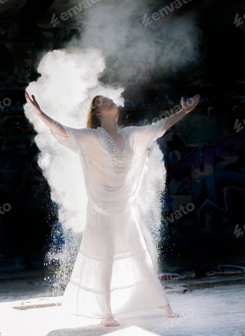 Preview: Powdered covered woman wearing long white dress, arms raised