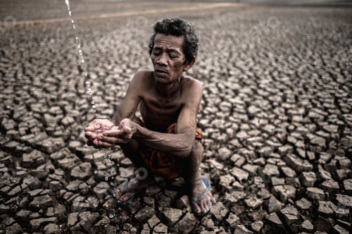 Preview: An elderly man sitting in touch with rain in the dry season, global warming, selection focus