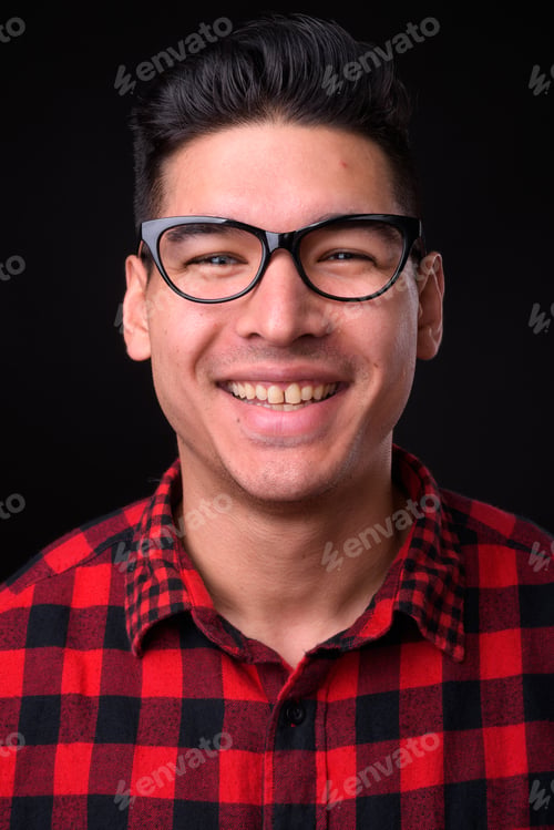 Preview: Young handsome multi-ethnic man against black background