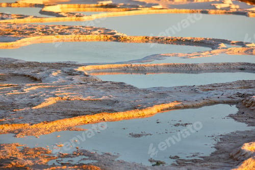 Preview: Pamukkale white mineral limestone natural pool at sunset. Turkey