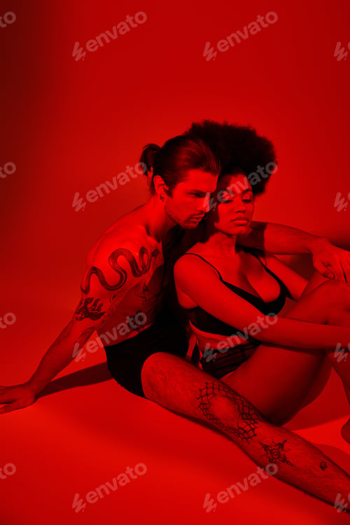 Preview: handsome man with tattoos posing alluringly with his pretty african american girlfriend, sexy couple