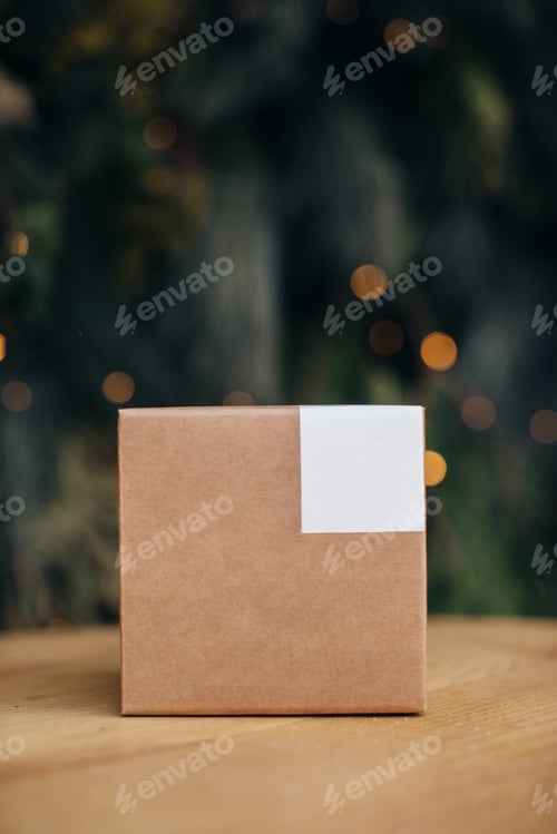 Preview: Mockup. Kraft paper boxes with white stickers on Christmas background.