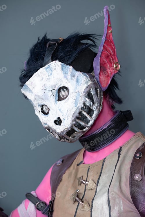 Preview: Female cosplayer dressed as a pink monster with a skull mask