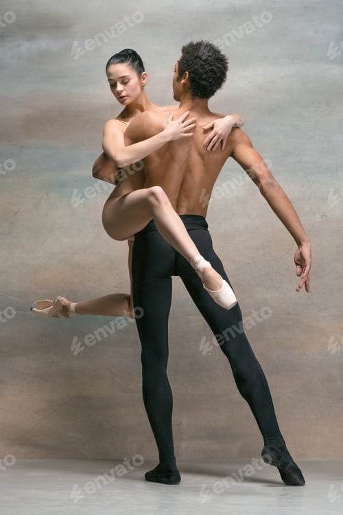 Preview: Couple of ballet dancers posing over gray background
