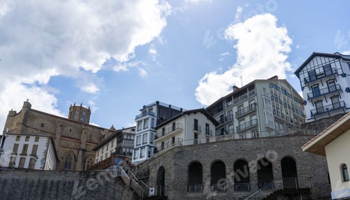 Preview: Close-up of the buildings and houses of the town of Getaria with blue sky and some clouds