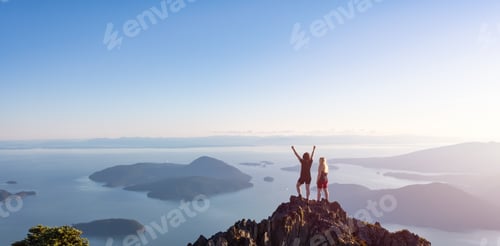 Preview: Adventurous Caucasian Woman Friends Hiking on top of a Rocky Mountain Cliff