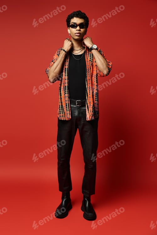 Preview: Stylish Man Strikes a Pose on Vibrant Red