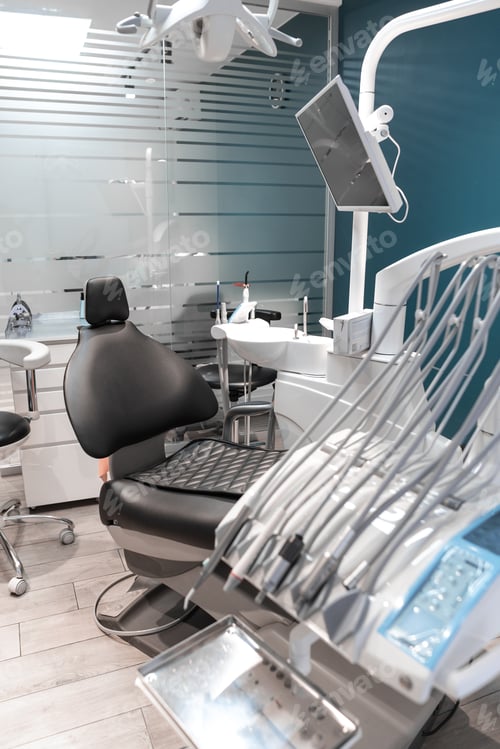 Preview: An empty dental office in which the patient's chair, prepared for the appointment, demonstrates a