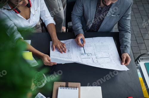 Preview: Top view of unrecognizable architects sitting and working at desk in office, cooperation concept