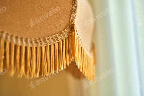 Preview: Clos shot of a fringed lampshade