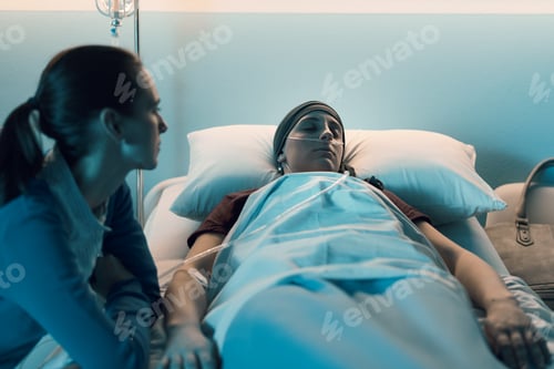 Preview: Caring woman assisting her friend with cancer at hospital