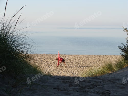Preview: Woman Doing Yoga on a Serene Sandy Beach