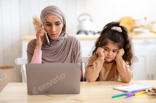 Preview: Bored Child. Lonely Arab Girl Sitting Next To Her Busy Muslim Mom