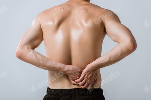 Preview: back view of shirtless sportsman with lower back pain isolated on grey