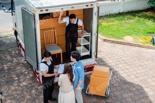 Preview: Asian Couple check while unloading boxes and furniture from a pickup truck