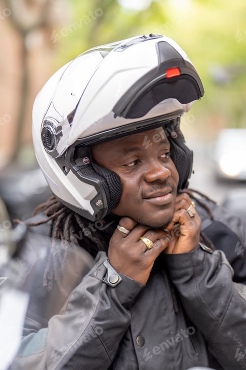 Preview: Man on motorcycle fastening safety helmet