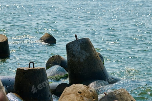 Preview: Large concrete breakwaters tetrapods near sea, close up. Blocks and stones, beautiful seascape