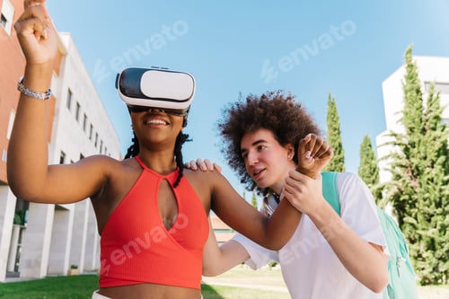 Preview: Education with modern gadgets and technologies. Two students laughing while trying out VR glasses