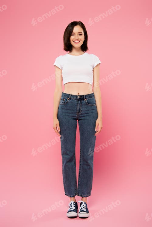 Preview: full length view of beautiful smiling girl isolated on pink