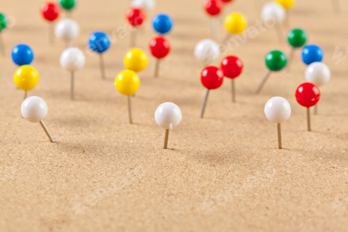 Preview: Group of thumbtacks pinned on corkboard