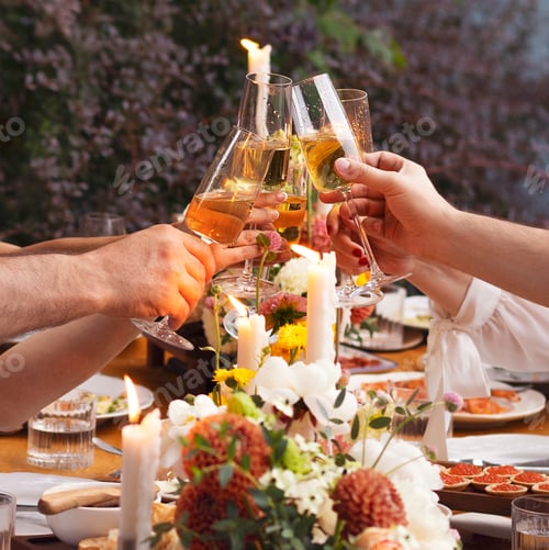 Preview: Happy friends saying cheers and showing their champagne glasses full of sparkling wine