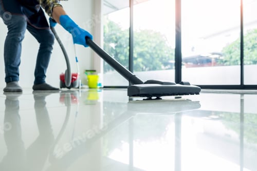 Preview: Young attractive man is cleaning vacuum commercial cleaning equipment on floor at home helping wife