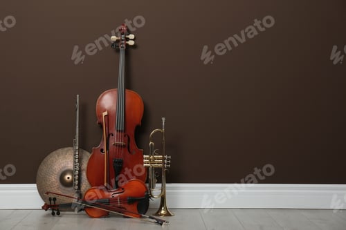 Preview: Set of different musical instruments near brown wall indoors, space for text