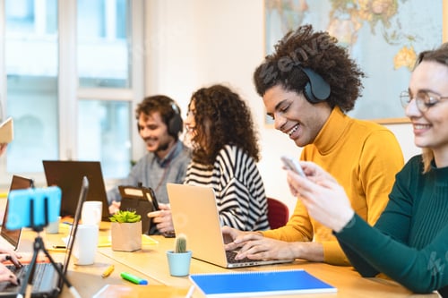 Preview: Young friends working together inside co-working creative space