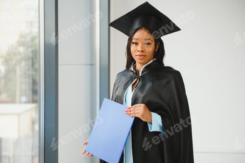 Preview: African American graduate holding diploma.