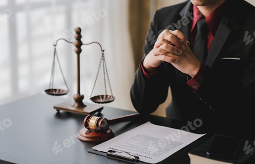 Preview: concept of justice and law A male judge in the courtroom on a wooden table and a male counselor or l