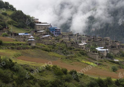 Preview: a small town sits high on a hill covered in mist