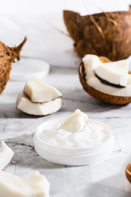 Preview: A piece of coconut in coconut oil in a jar and coconut. Natural cosmetic. Vertical view