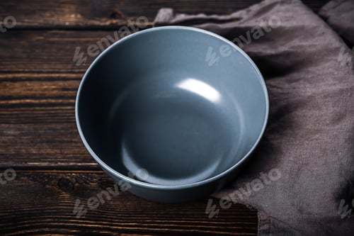 Preview: Empty gray plate on a wooden background. Kitchen mockup