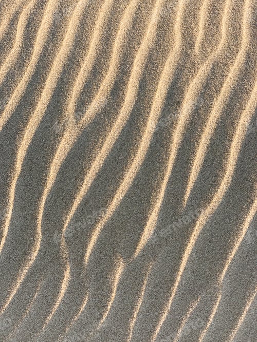 Preview: Vertical shot of the texture of sand during sunset