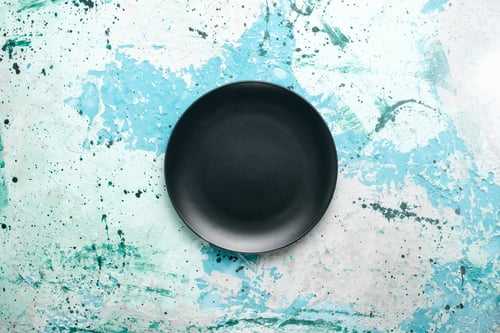Preview: top view empty round plate dark colored on the blue background color plate kitchen cutlery glass