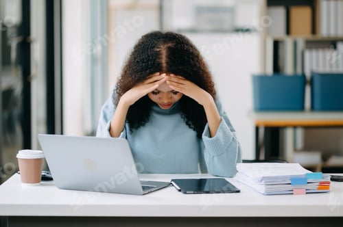Preview: Business woman is stressed, bored, and overthinking from working on tablet at office.