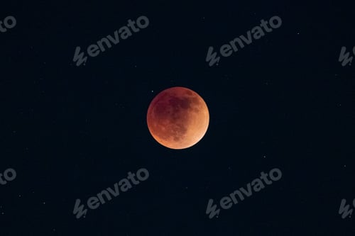Preview: Blood moon total lunar eclipse super moon rising against dark sky