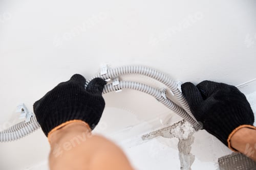 Preview: Electrician Fitting Conduit Pipes on a Ceiling
