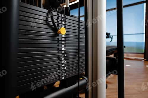 Preview: Stacked iron plates of weight machine in gym