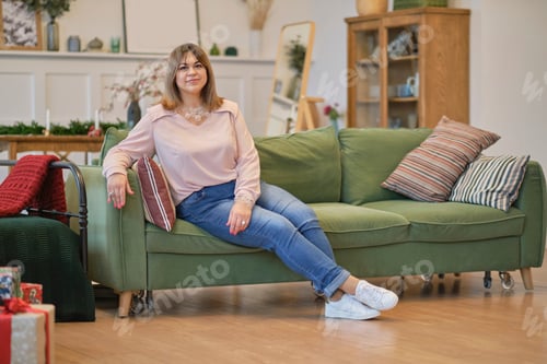 Preview: self-sufficient confident middle-aged woman. sitting on a chair in a confident posture.
