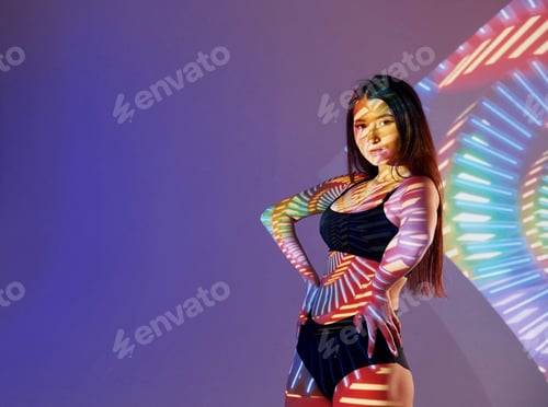 Preview: In underwear. Beautiful young woman is in projector neon lights in the studio