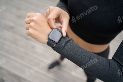 Preview: smart watch uses a sporty woman runner outdoor training, pulse and calories